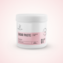A white plastic jar of Radeq Lab Sugar Paste Classic Line, featuring a pink label with black text, set against a soft pink background.
